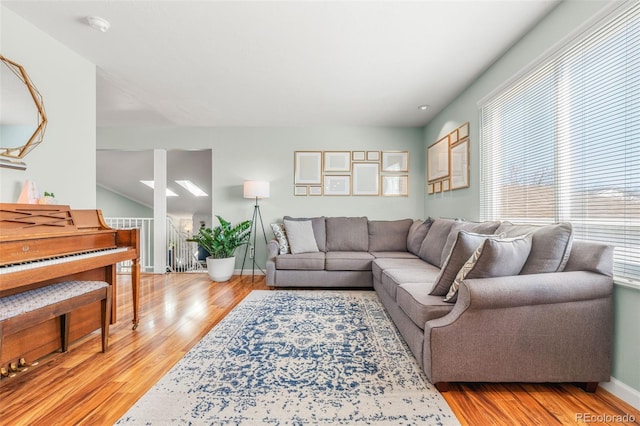 living area with light wood-style flooring and baseboards