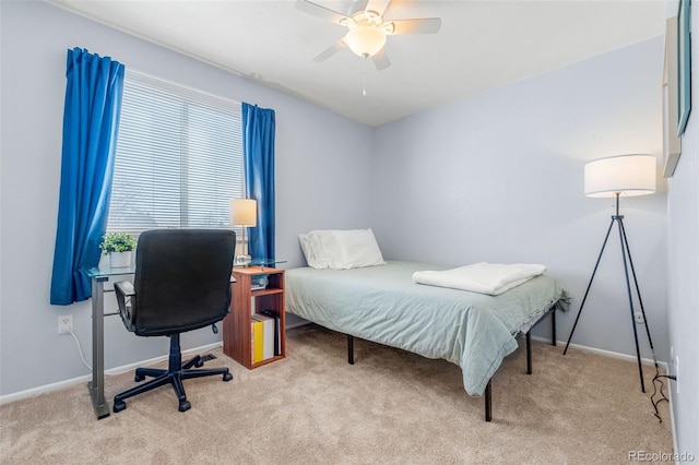 bedroom featuring light carpet, ceiling fan, and baseboards