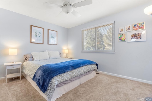 bedroom featuring light carpet, ceiling fan, and baseboards