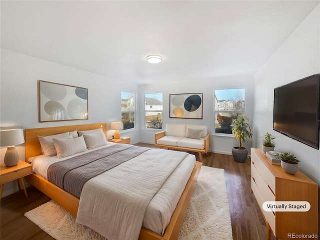 bedroom with dark hardwood / wood-style flooring