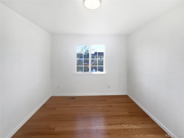 spare room with hardwood / wood-style flooring