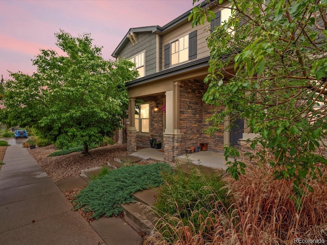 14823 W 70th Dr Unit A, Arvada, CO 80007 - view of front facade featuring stone siding and covered porch
