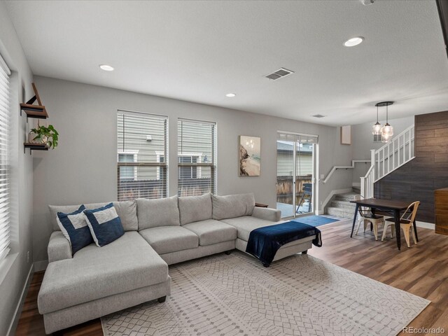 14823 W 70th Dr Unit A, Arvada, CO 80007 - living area with stairway, wood finished floors, baseboards, recessed lighting, and a chandelier