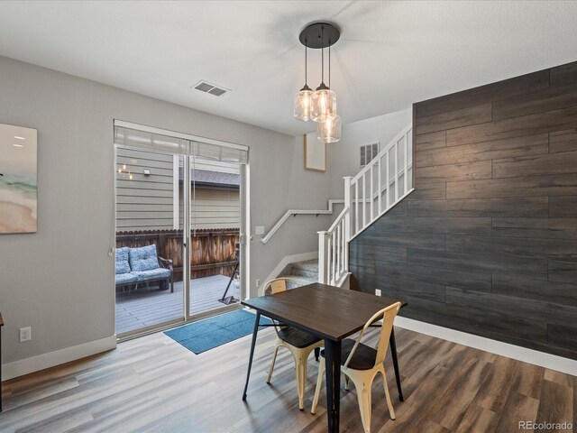 14823 W 70th Dr Unit A, Arvada, CO 80007 - dining room with stairway, baseboards, wood finished floors, and a chandelier