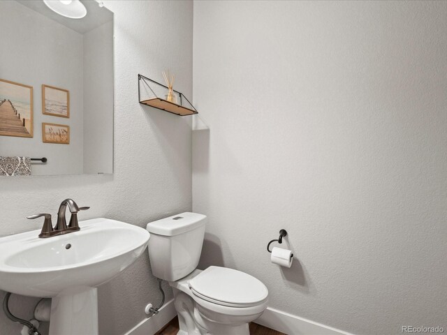 14823 W 70th Dr Unit A, Arvada, CO 80007 - half bathroom featuring toilet and a sink