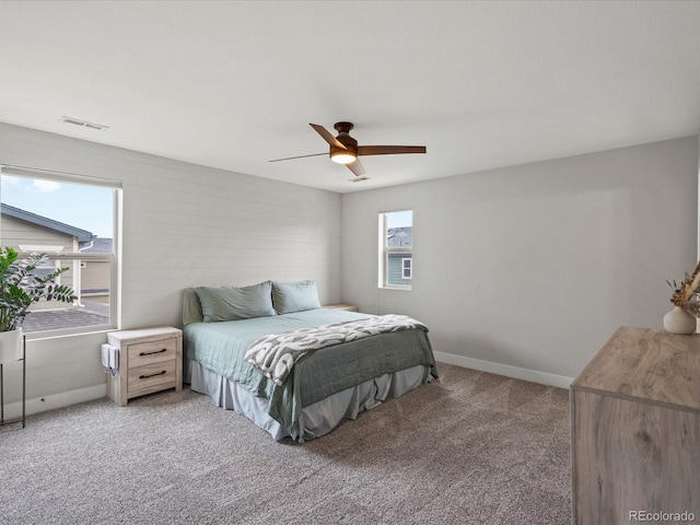 14823 W 70th Dr Unit A, Arvada, CO 80007 - bedroom with light carpet, ceiling fan, and baseboards