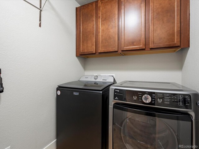 14823 W 70th Dr Unit A, Arvada, CO 80007 - laundry room with washing machine and clothes dryer and cabinet space