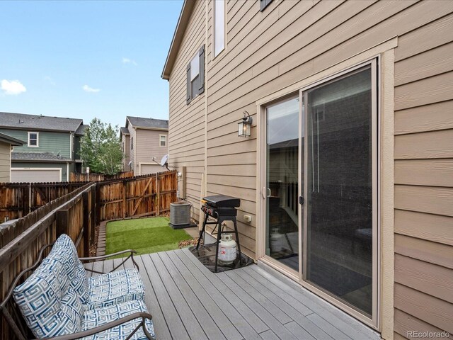 14823 W 70th Dr Unit A, Arvada, CO 80007 - wooden deck featuring central AC unit and area for grilling
