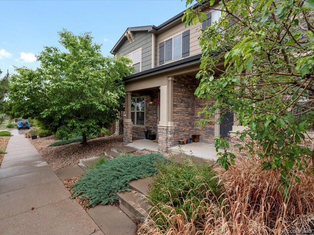 14823 W 70th Dr Unit A, Arvada, CO 80007 - view of home's exterior featuring stone siding