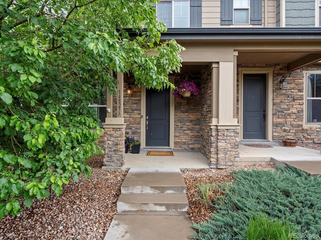 14823 W 70th Dr Unit A, Arvada, CO 80007 - view of exterior entry with stone siding and covered porch