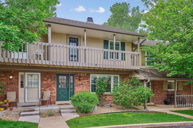 6880 E Appleton Cir, Centennial, CO 80112 - view of front of property with a balcony, a chimney, brick siding, and covered porch