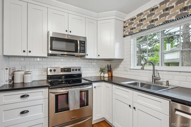 6880 E Appleton Cir, Centennial, CO 80112 - kitchen with stainless steel appliances, a sink, and dark countertops