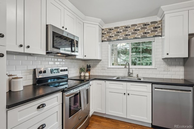 6880 E Appleton Cir, Centennial, CO 80112 - kitchen featuring appliances with stainless steel finishes, a sink, dark countertops, and white cabinets