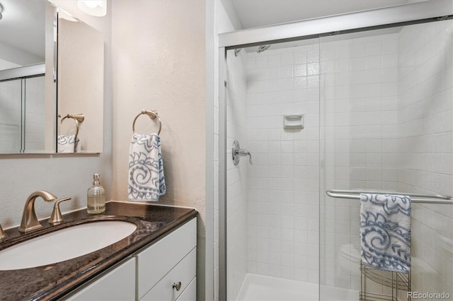 6880 E Appleton Cir, Centennial, CO 80112 - bathroom with vanity, a stall shower, and a textured wall
