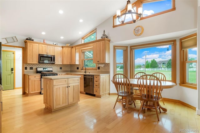 41504 Vista Rdg, Parker, CO 80138 - kitchen featuring appliances with stainless steel finishes, light countertops, light brown cabinets, backsplash, and healthy amount of natural light
