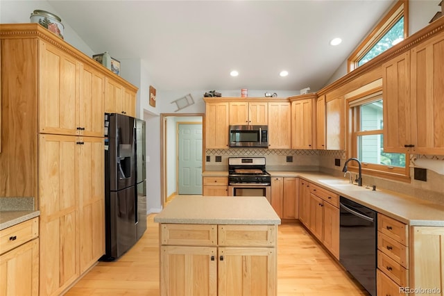 41504 Vista Rdg, Parker, CO 80138 - kitchen with black appliances, vaulted ceiling, light brown cabinets, a sink, and light wood-style flooring