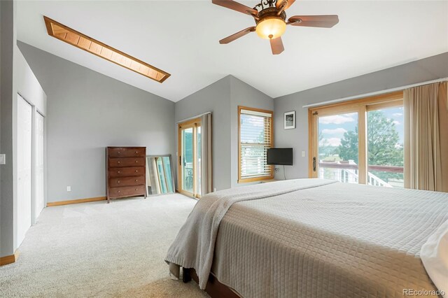 41504 Vista Rdg, Parker, CO 80138 - bedroom with lofted ceiling, access to exterior, multiple windows, carpet flooring, and a skylight