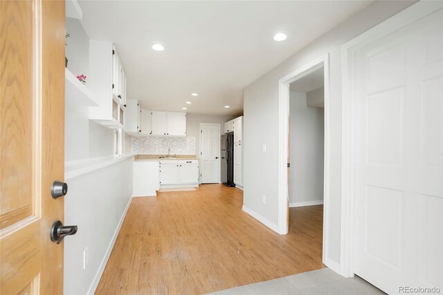 41504 Vista Rdg, Parker, CO 80138 - kitchen with freestanding refrigerator, a sink, white cabinetry, light wood-style flooring, and recessed lighting
