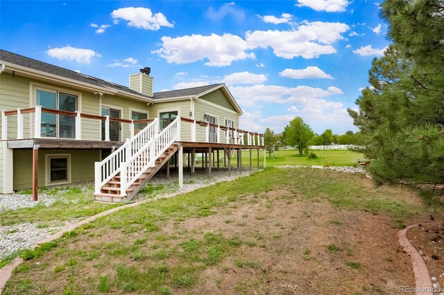 41504 Vista Rdg, Parker, CO 80138 - rear view of property with stairs, a wooden deck, and a chimney