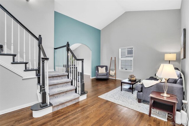 16655 W 2nd Ave, Golden, CO 80401 - living area featuring high vaulted ceiling, baseboards, wood finished floors, and stairway