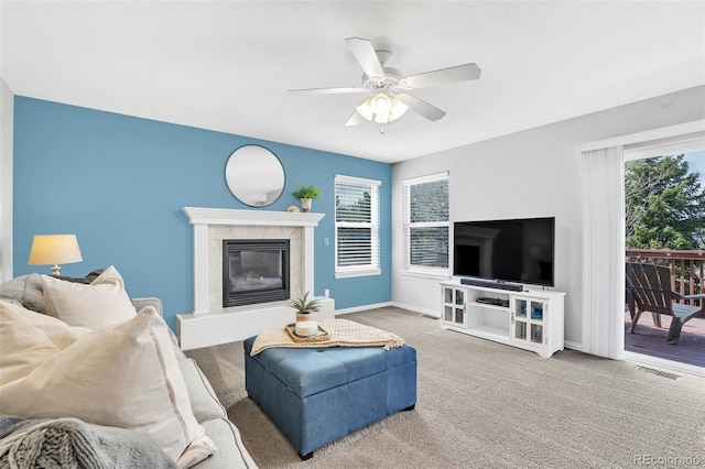 16655 W 2nd Ave, Golden, CO 80401 - living area featuring carpet, visible vents, baseboards, a fireplace, and ceiling fan