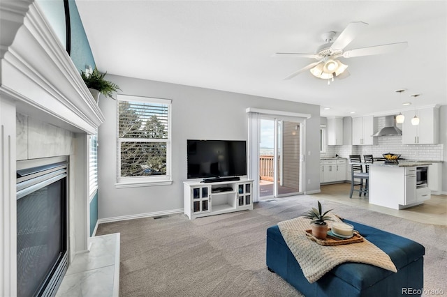 16655 W 2nd Ave, Golden, CO 80401 - living room with a high end fireplace, baseboards, ceiling fan, and light colored carpet