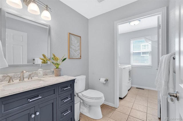 16655 W 2nd Ave, Golden, CO 80401 - bathroom with separate washer and dryer, vanity, toilet, tile patterned flooring, and visible vents