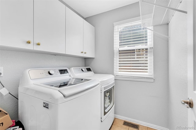 16655 W 2nd Ave, Golden, CO 80401 - washroom featuring visible vents, washing machine and dryer, light tile patterned flooring, baseboards, and cabinet space