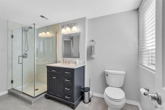16655 W 2nd Ave, Golden, CO 80401 - full bath featuring a shower stall, toilet, vanity, and tile patterned floors