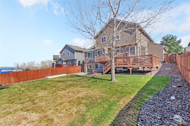 16655 W 2nd Ave, Golden, CO 80401 - back of property with a lawn, a wooden deck, a fenced backyard, and stairway