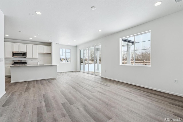 unfurnished living room with light hardwood / wood-style flooring