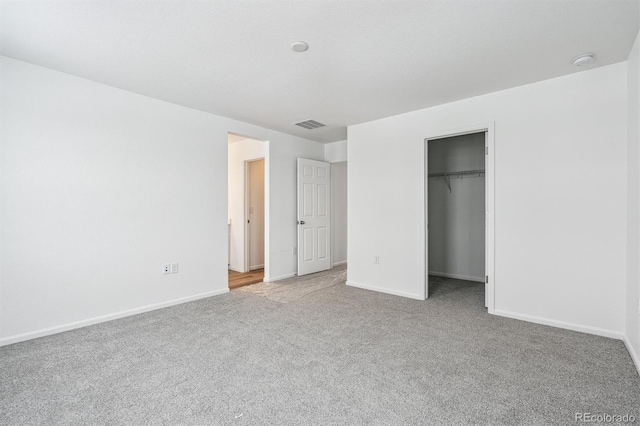 unfurnished bedroom with light carpet and a closet