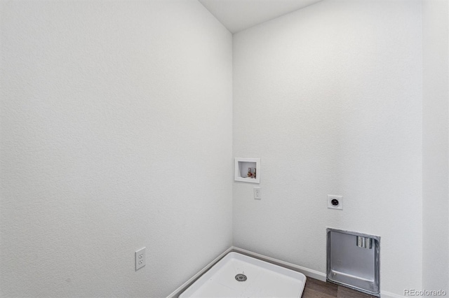 clothes washing area featuring hookup for an electric dryer, washer hookup, and dark wood-type flooring