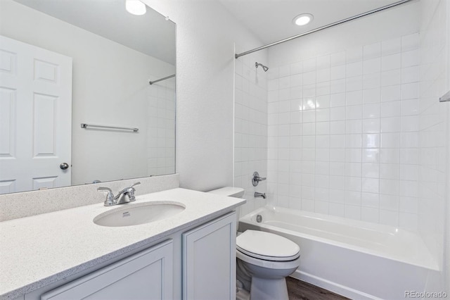 full bathroom with hardwood / wood-style floors, vanity, toilet, and bathing tub / shower combination