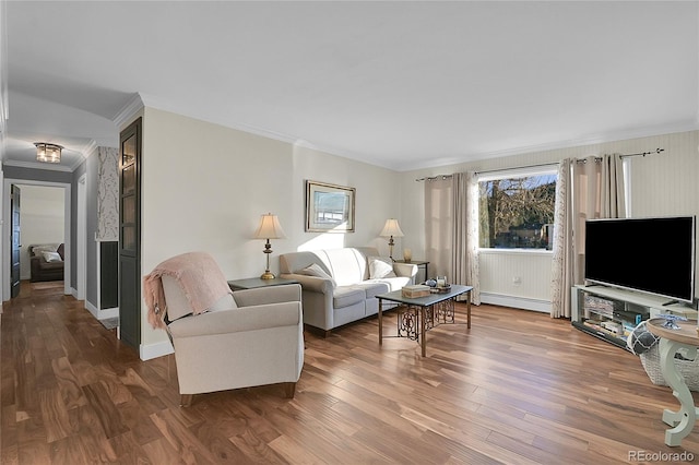 living room featuring ornamental molding, hardwood / wood-style flooring, and a baseboard radiator