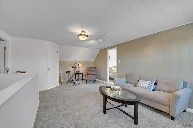 living room featuring lofted ceiling, light colored carpet, and rail lighting