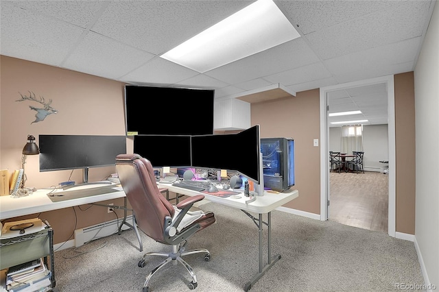 office area featuring a baseboard radiator, a paneled ceiling, and light carpet