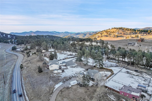 snowy aerial view with a mountain view