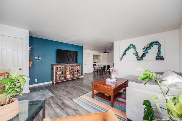 living room with hardwood / wood-style floors and ceiling fan