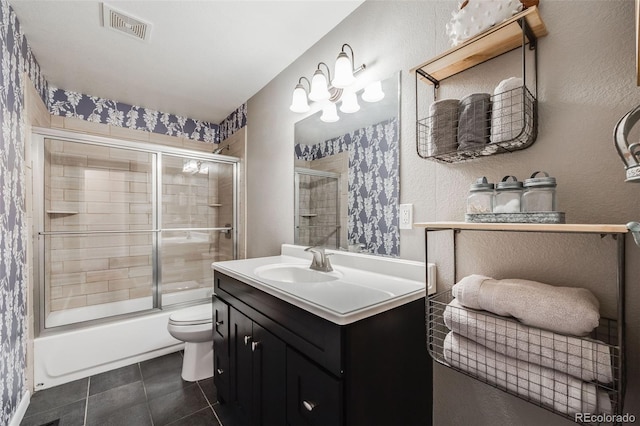 full bathroom featuring tile patterned flooring, vanity, combined bath / shower with glass door, and toilet