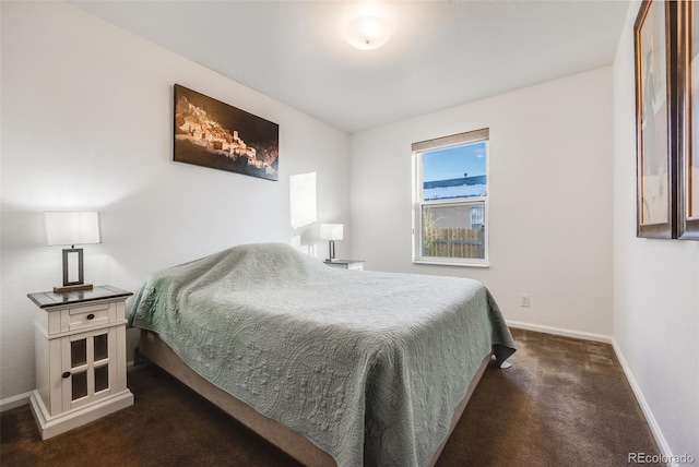 bedroom featuring dark colored carpet