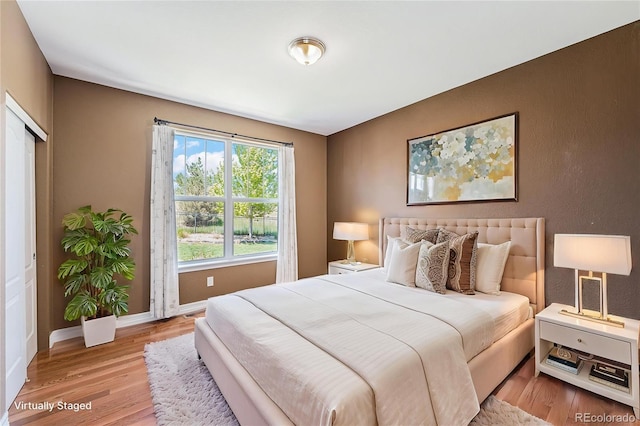 26004 E Elmhurst Pl, Aurora, CO 80016 - bedroom with light wood-style floors and baseboards