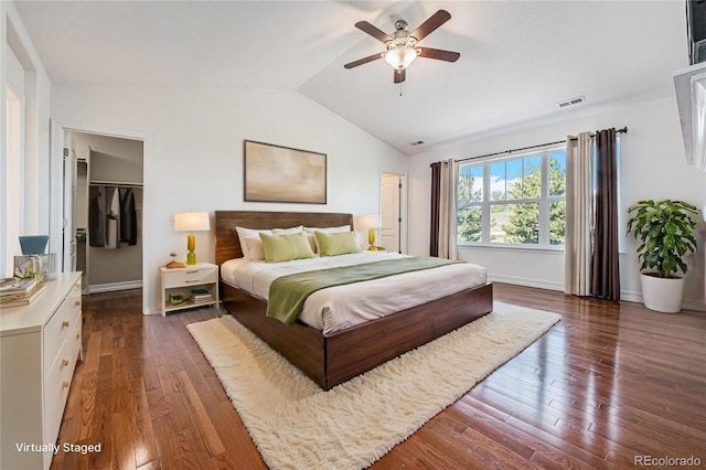 26004 E Elmhurst Pl, Aurora, CO 80016 - bedroom with vaulted ceiling, hardwood / wood-style flooring, baseboards, a spacious closet, and ceiling fan