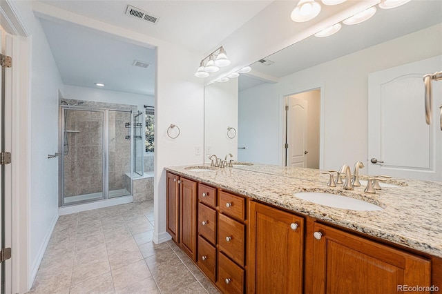26004 E Elmhurst Pl, Aurora, CO 80016 - bathroom with double vanity, a stall shower, tile patterned flooring, and baseboards