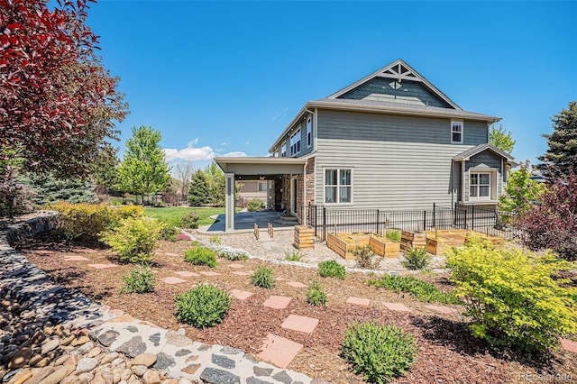 26004 E Elmhurst Pl, Aurora, CO 80016 - back of house with a patio area and a garden
