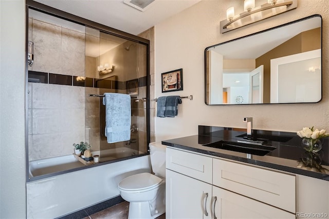 full bath with combined bath / shower with glass door, toilet, and vanity