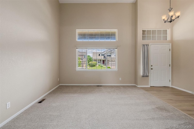 9417 Burgundy Cir, Highlands Ranch, CO 80126 - foyer featuring a chandelier, carpet, and a high ceiling