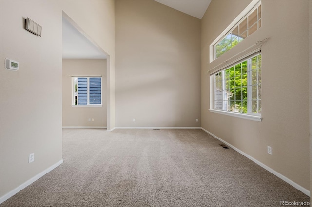 9417 Burgundy Cir, Highlands Ranch, CO 80126 - carpeted spare room featuring baseboards and a towering ceiling