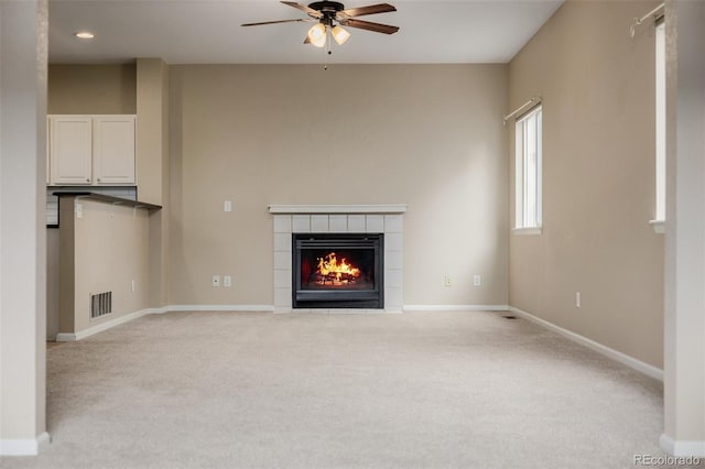 9417 Burgundy Cir, Highlands Ranch, CO 80126 - unfurnished living room featuring carpet flooring, ceiling fan, and a fireplace
