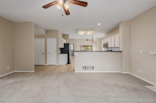 9417 Burgundy Cir, Highlands Ranch, CO 80126 - unfurnished living room featuring light colored carpet, a ceiling fan, and recessed lighting